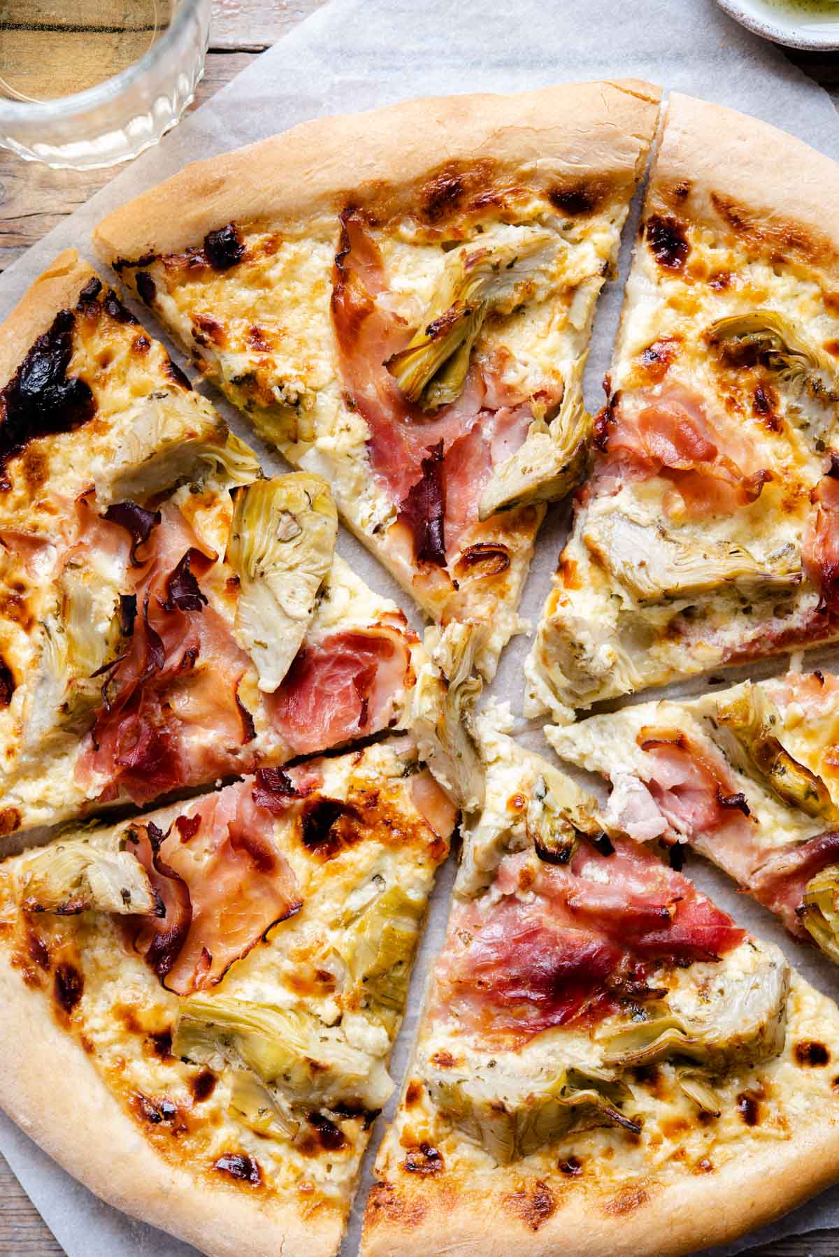 A close up of artichoke pizza with ham