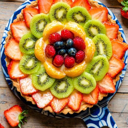 An overhead shot of a fruit tart layered with fresh fruit