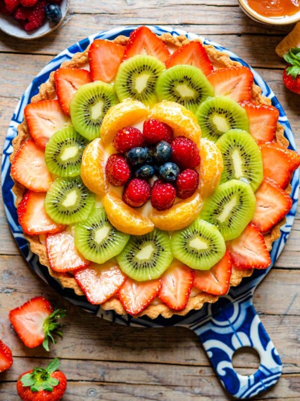 An overhead shot of a fruit tart layered with fresh fruit