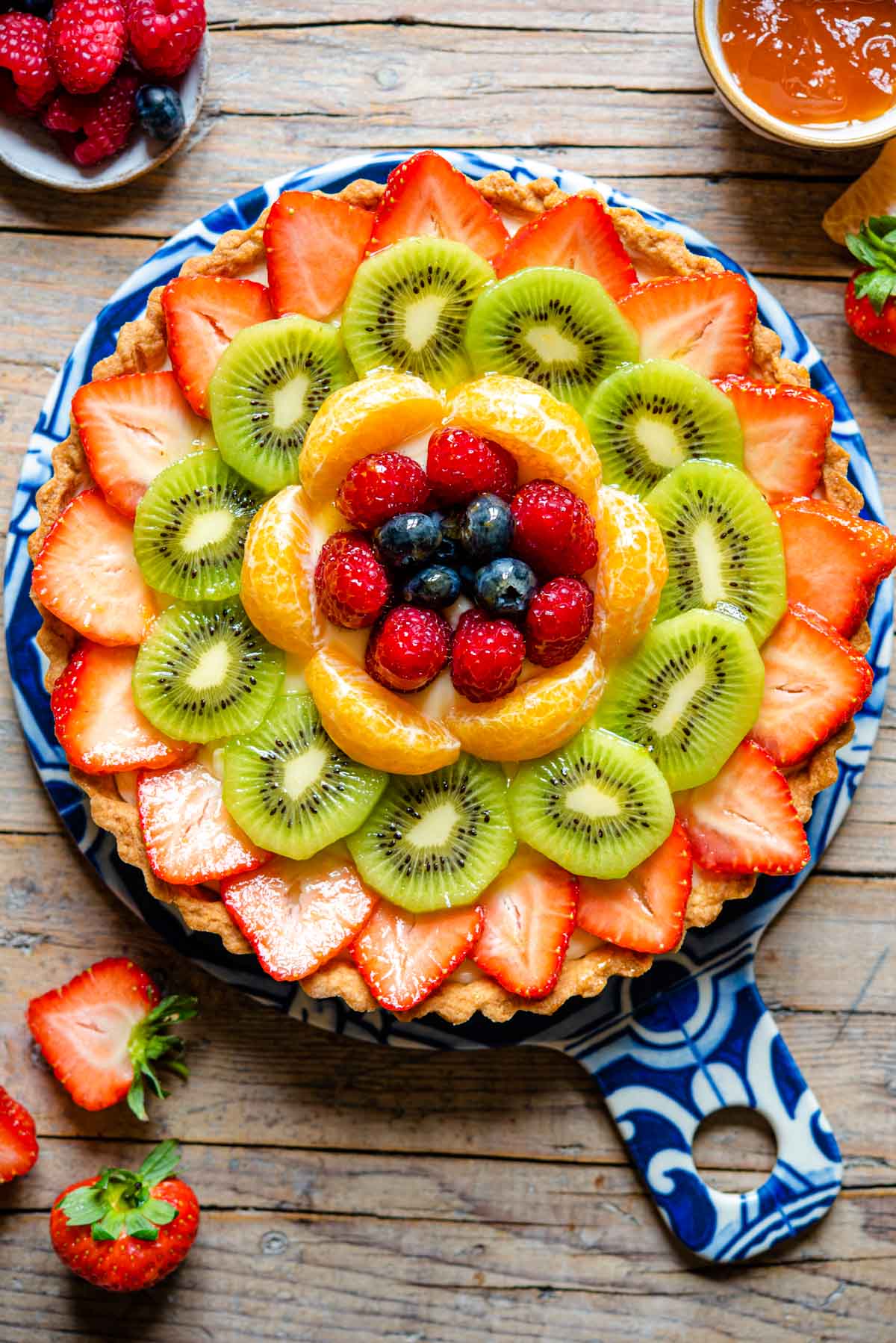 An overhead shot of a fruit tart layered with fresh fruit