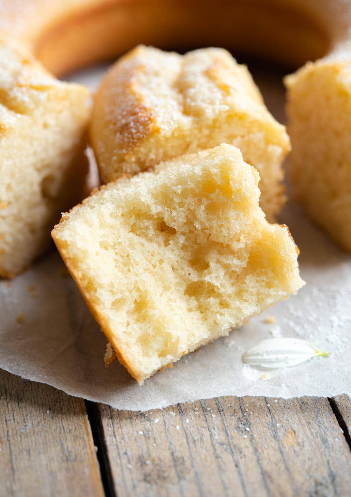 A close up of a slice of cake cut in half so you can see the soft texture