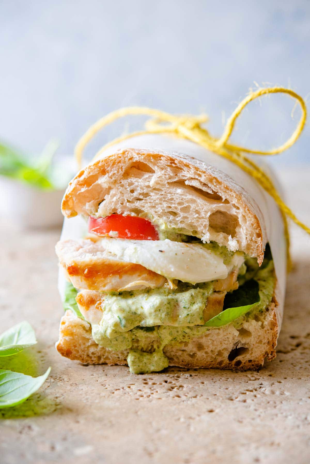 A close up of a chicken ciabatta sandwich with pesto