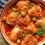 A close up of chicken cacciatore in a skillet