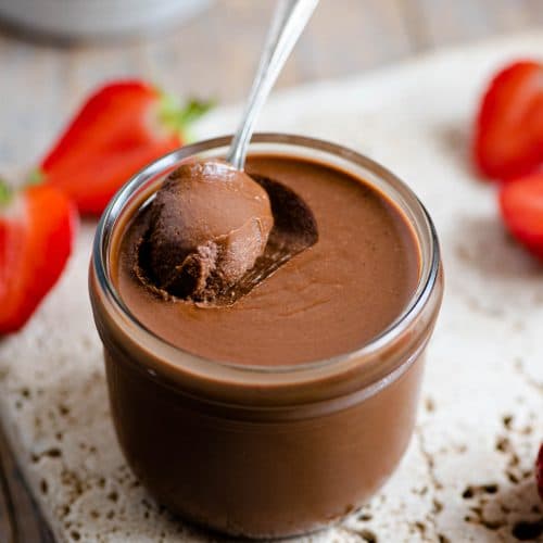 A close up of homemade nutella in a jar with a spoon