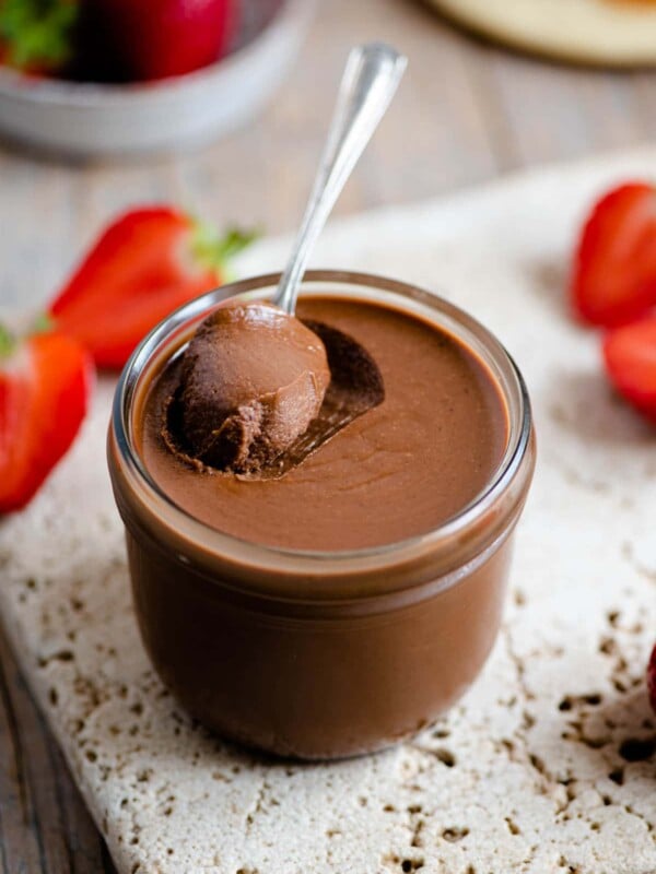 A close up of homemade nutella in a jar with a spoon