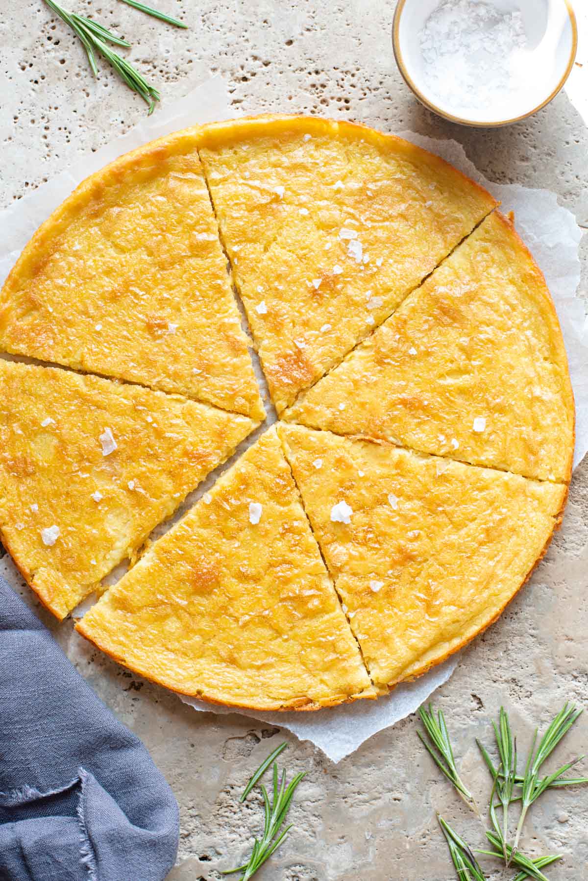 An overhead shot of a Tuscan chickpea flatbread on a stone worktop