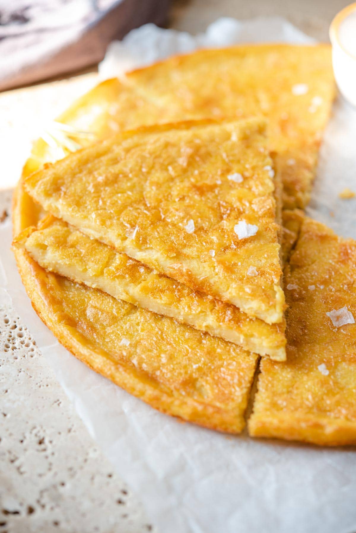 A close up of two slices of Italian farinata flatbread