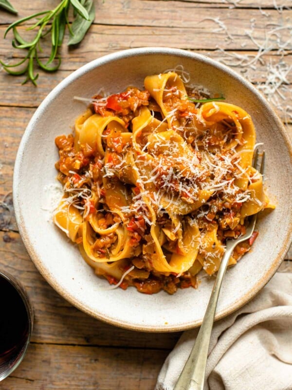 An overhead shot of a bowl of pasta on a wooden surface