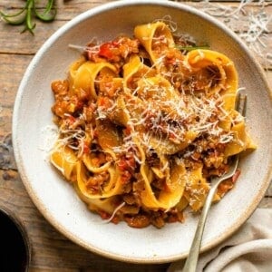 An overhead shot of a bowl of vegetable ragu and pasta