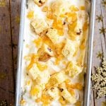 An overhead shot of panettone ice cream in a loaf tin topped with candied peel