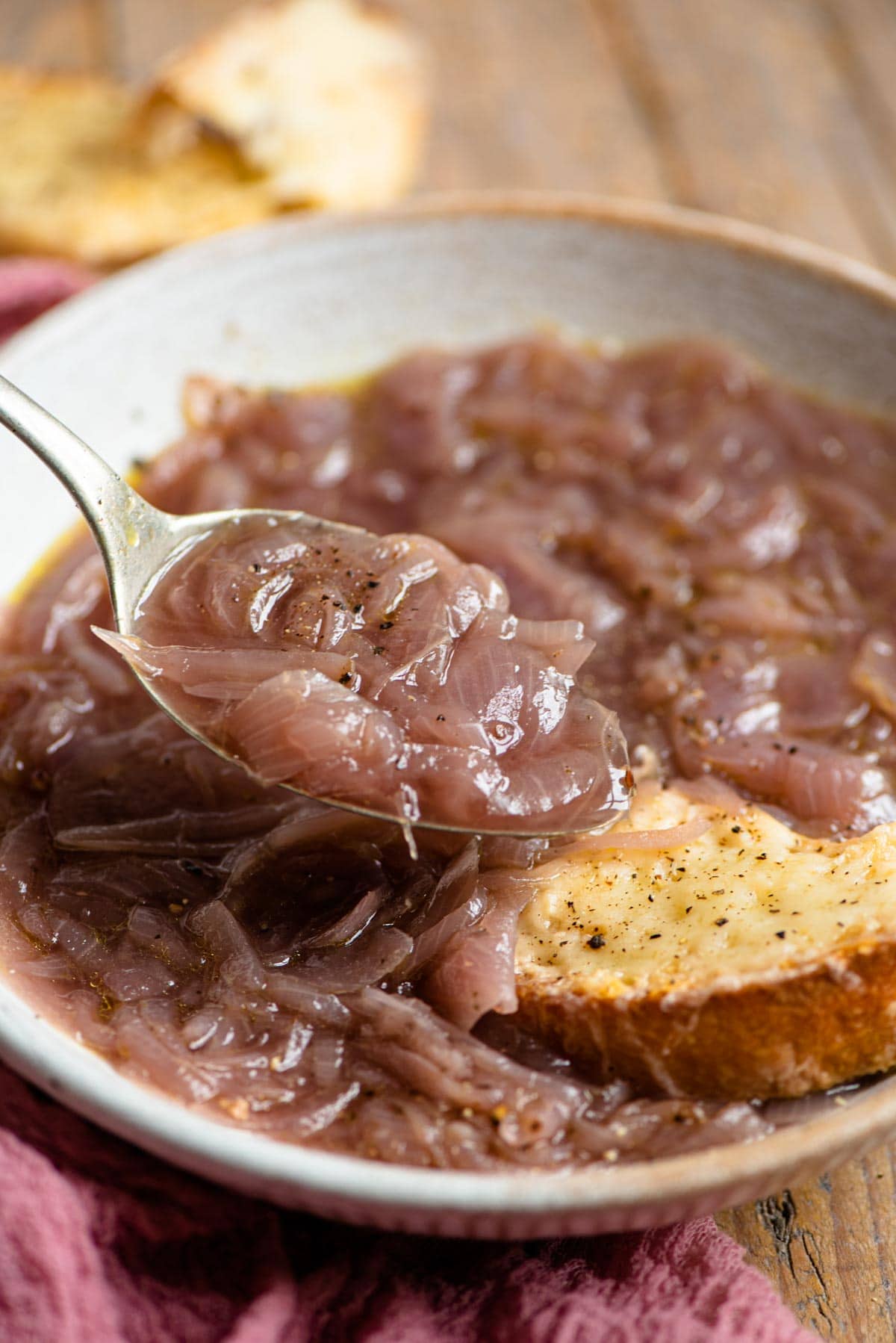 A close up of a spoonful of Carabaccia Tuscan Onion Soup