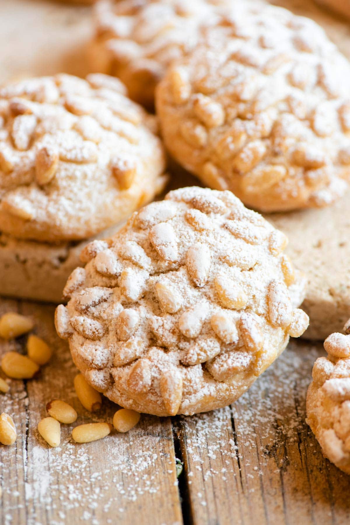 A close up of an Italian cookie with pine nuts