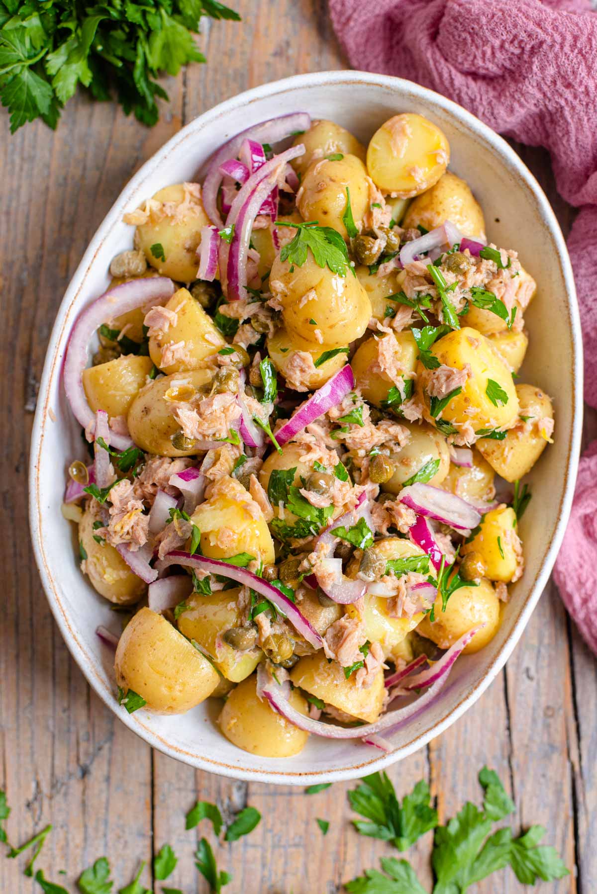 An overhead shot of a tuna potato salad in a large serving bowl