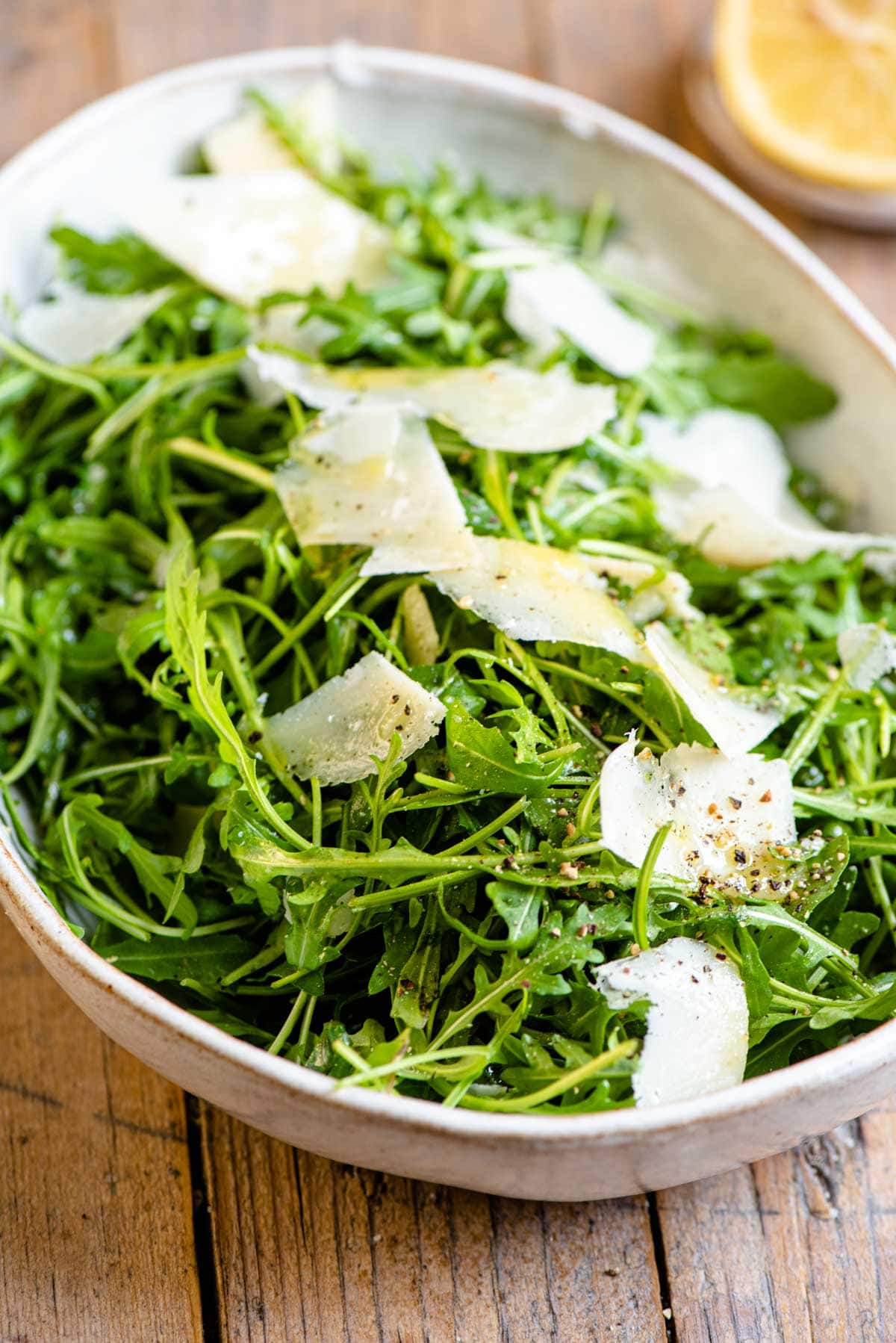A close up of an arugula salad in a bowl