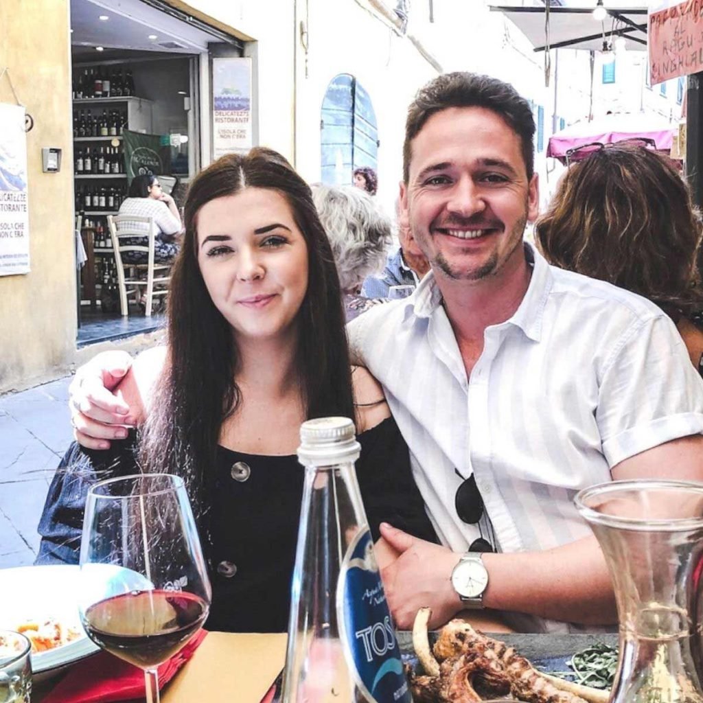 Emily and Nathan sitting at an Italian restaurant in Lucca