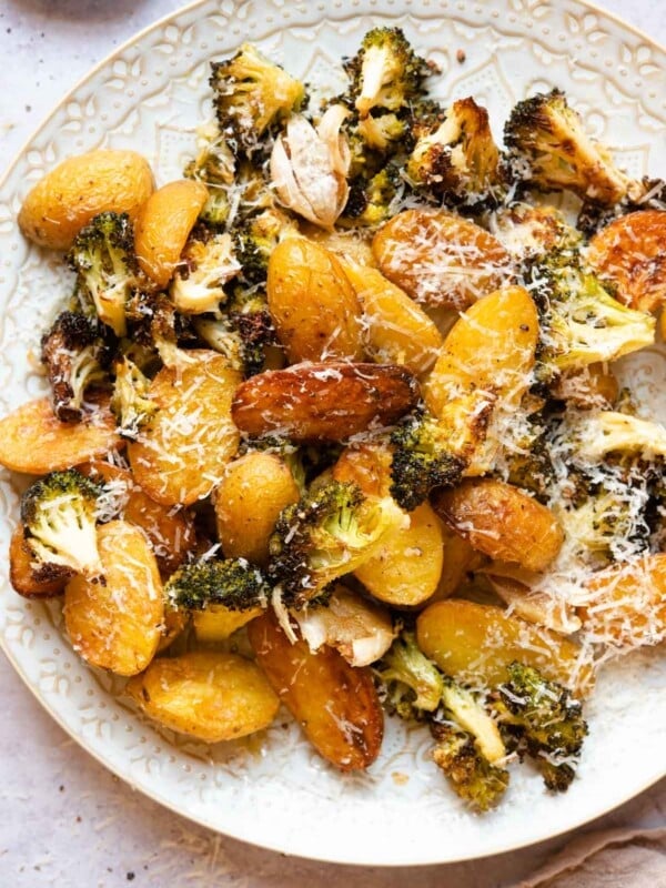 An overhead shot of roasted potatoes and broccoli on a plate