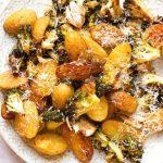 A close up of roasted potatoes and broccoli