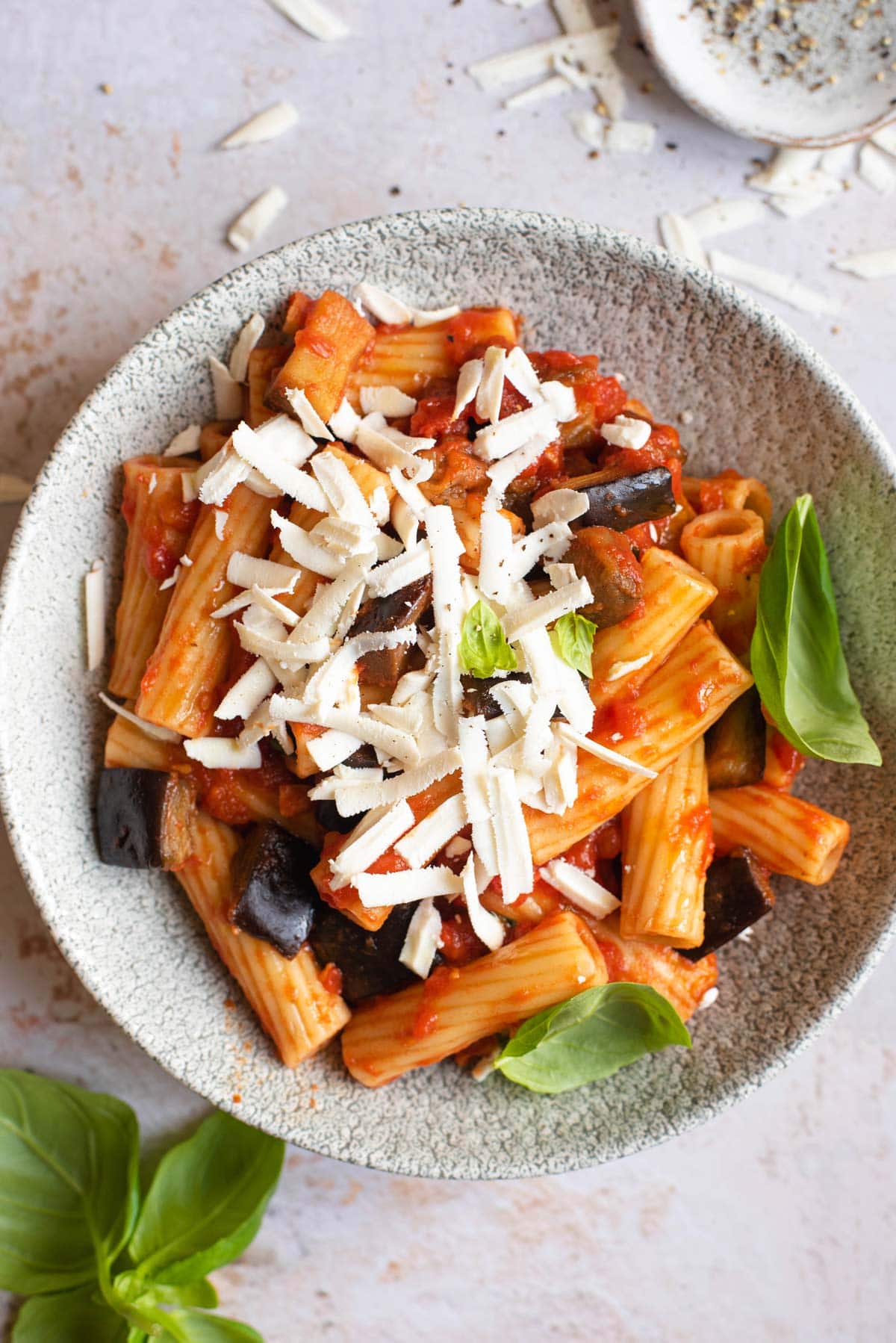 An overhead shot of Pasta alla Norma in a bowl topped with cheese