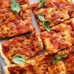 An overgead shot of a focaccia pizza cut into slices