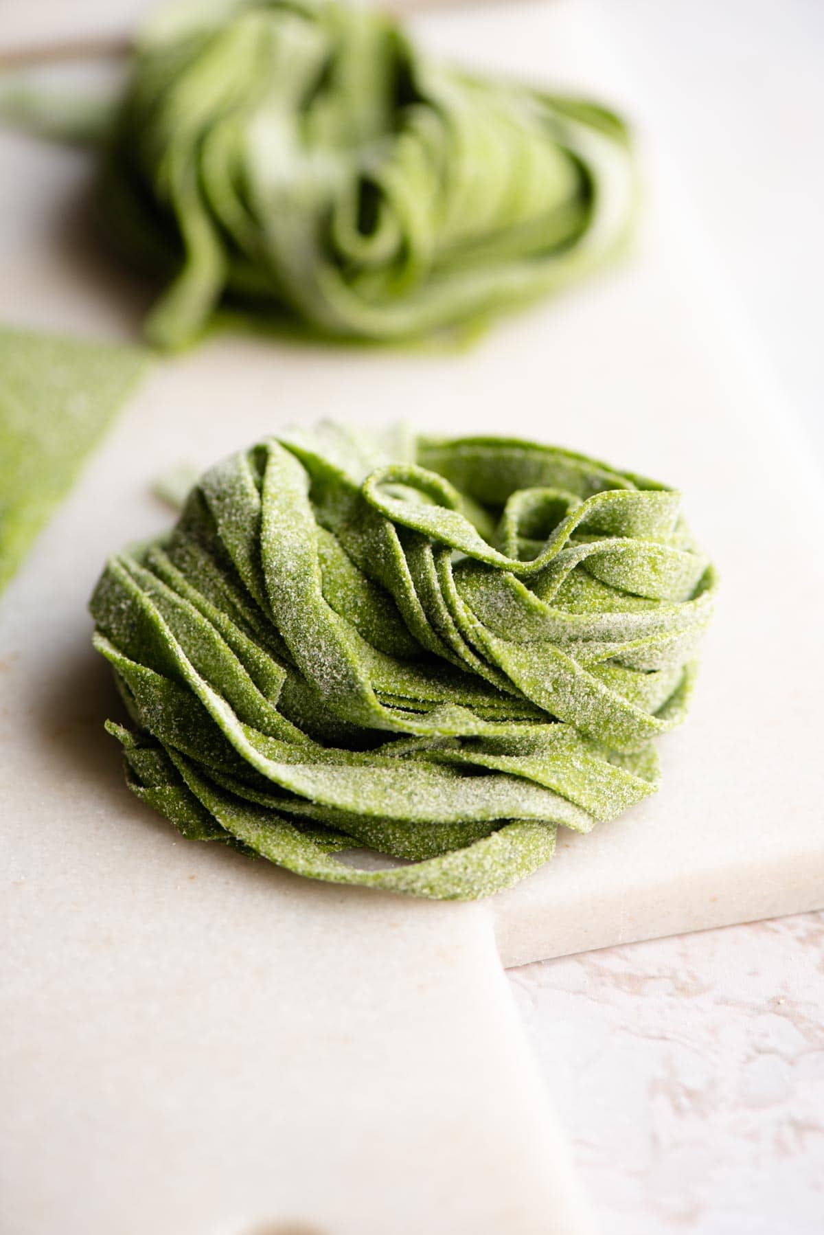 A close up of raw spinach tagliatelle