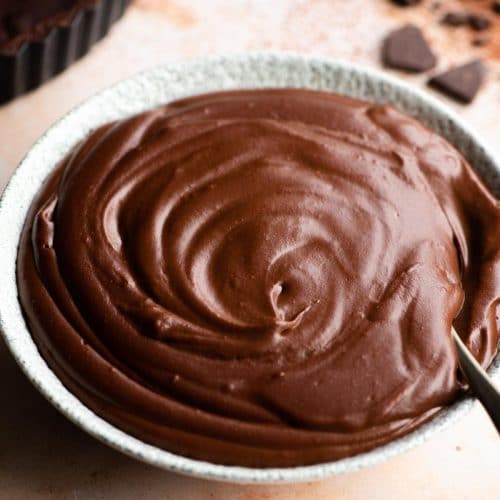 A close up of a bowl of chocolate pastry cream