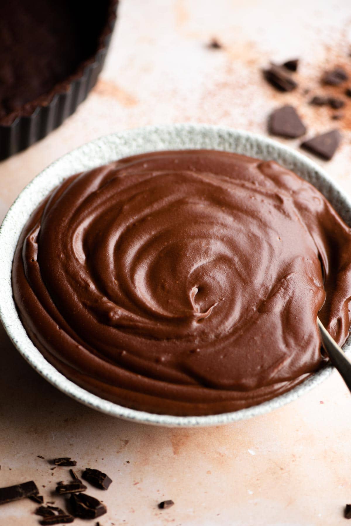 A close up of a bowl of chocolate pastry cream