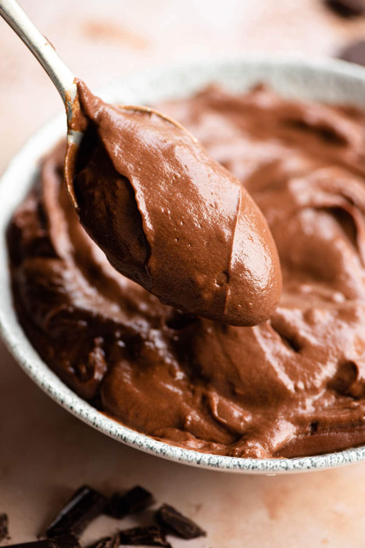 A close up of a spoonful of chocolate pastry cream
