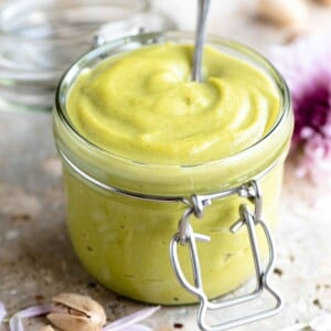 A close up of pistachio cream in a jar