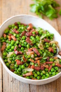 Peas and pancetta in a large serving bowl