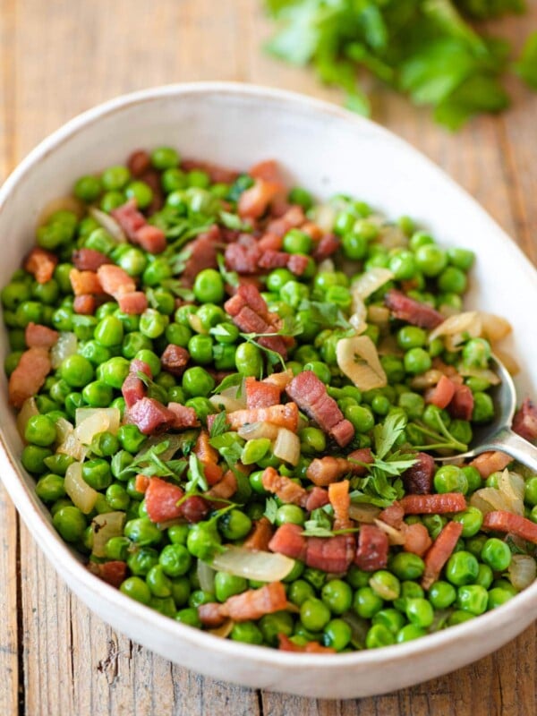 Peas and pancetta in a large serving bowl