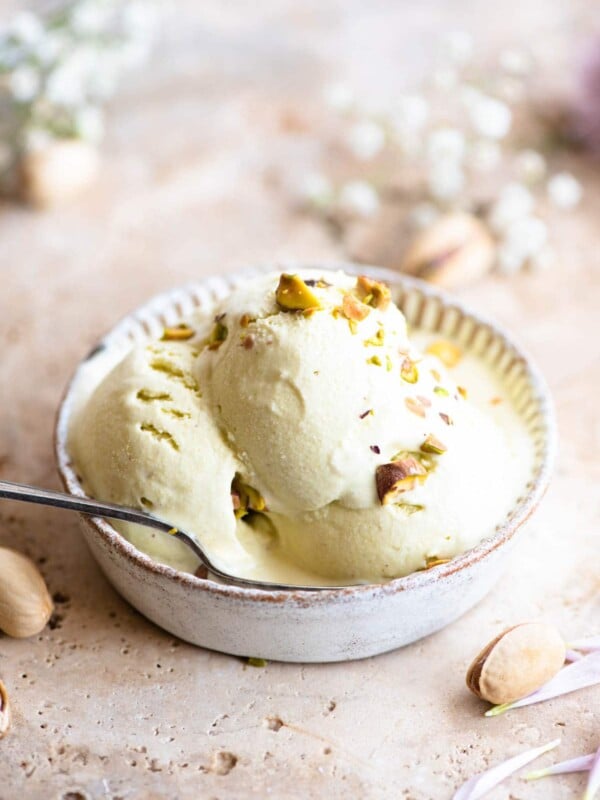 Three scoops of pistachio ice cream in a rustic looking ramekin