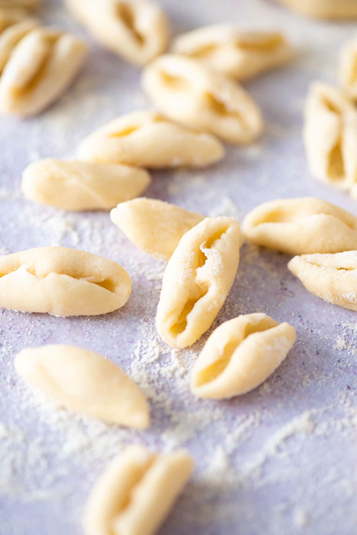 A close up of fresh cavatelli pasta on a blue work surface