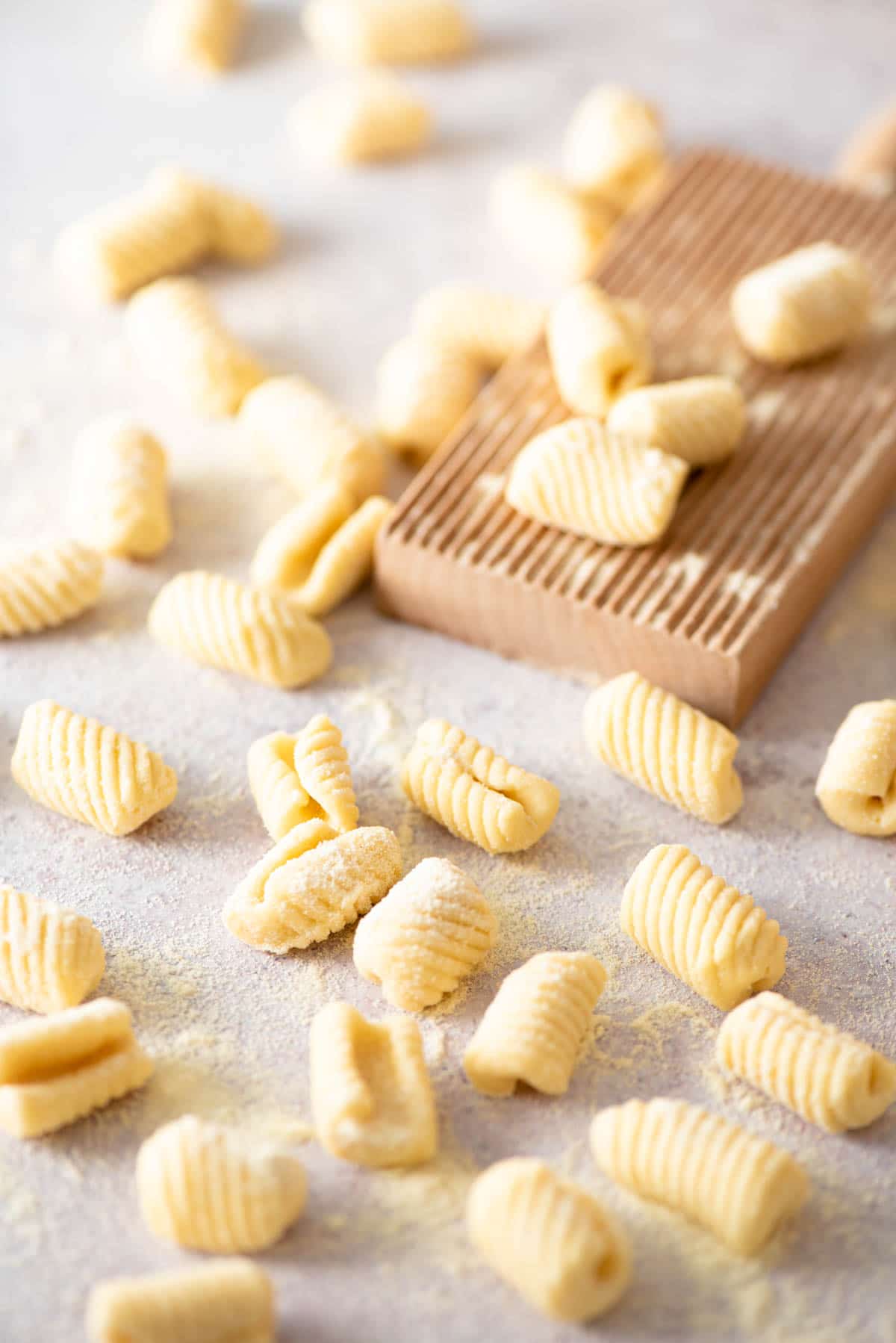 Gnochetti Sardi on a work surface with a gnocchi board