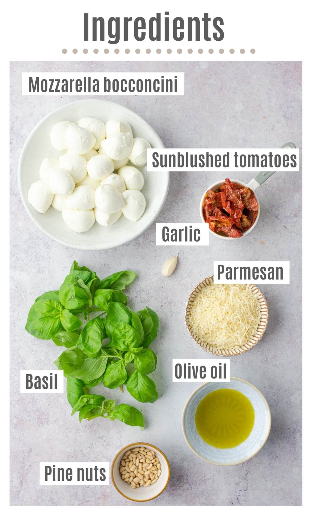 An overhead shot of all the ingredients you need to make mozzarella bocconcini, pesto and tomatoes