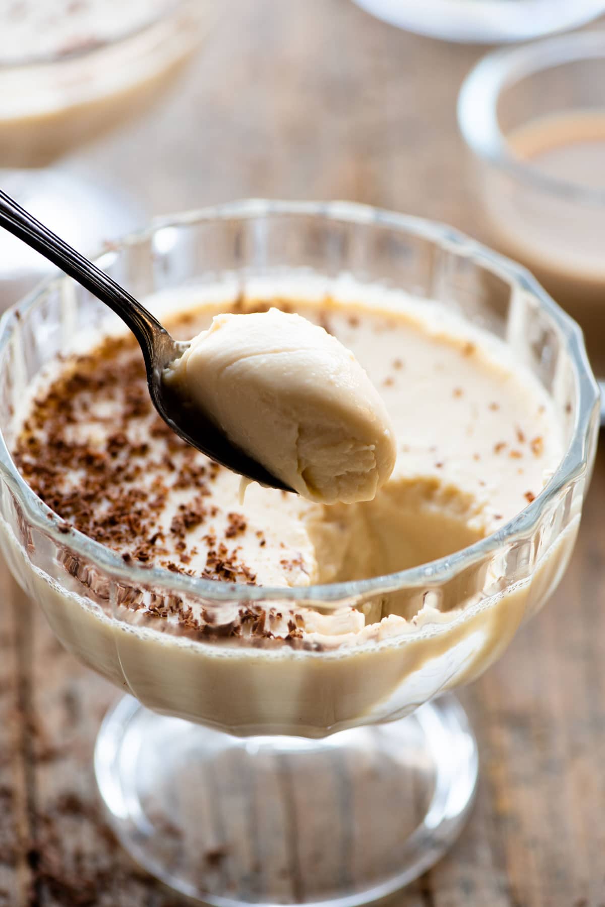 A close up of a spoonful of a baileys panna cotta