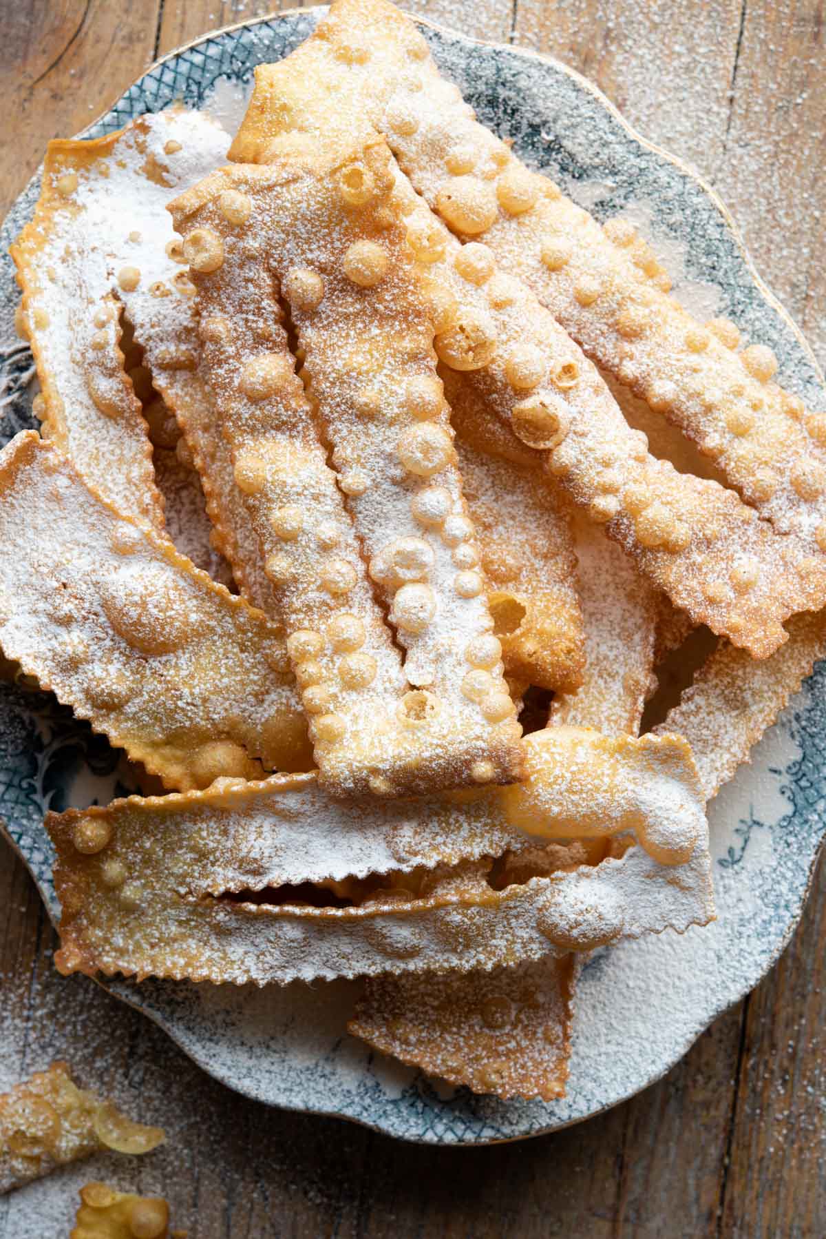 Crispy Italian fried pastries on a blue patterned plate