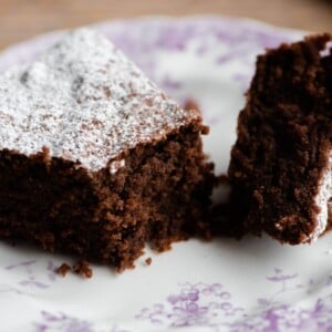 A slice of Torta Caprese cake on a plate cut in half