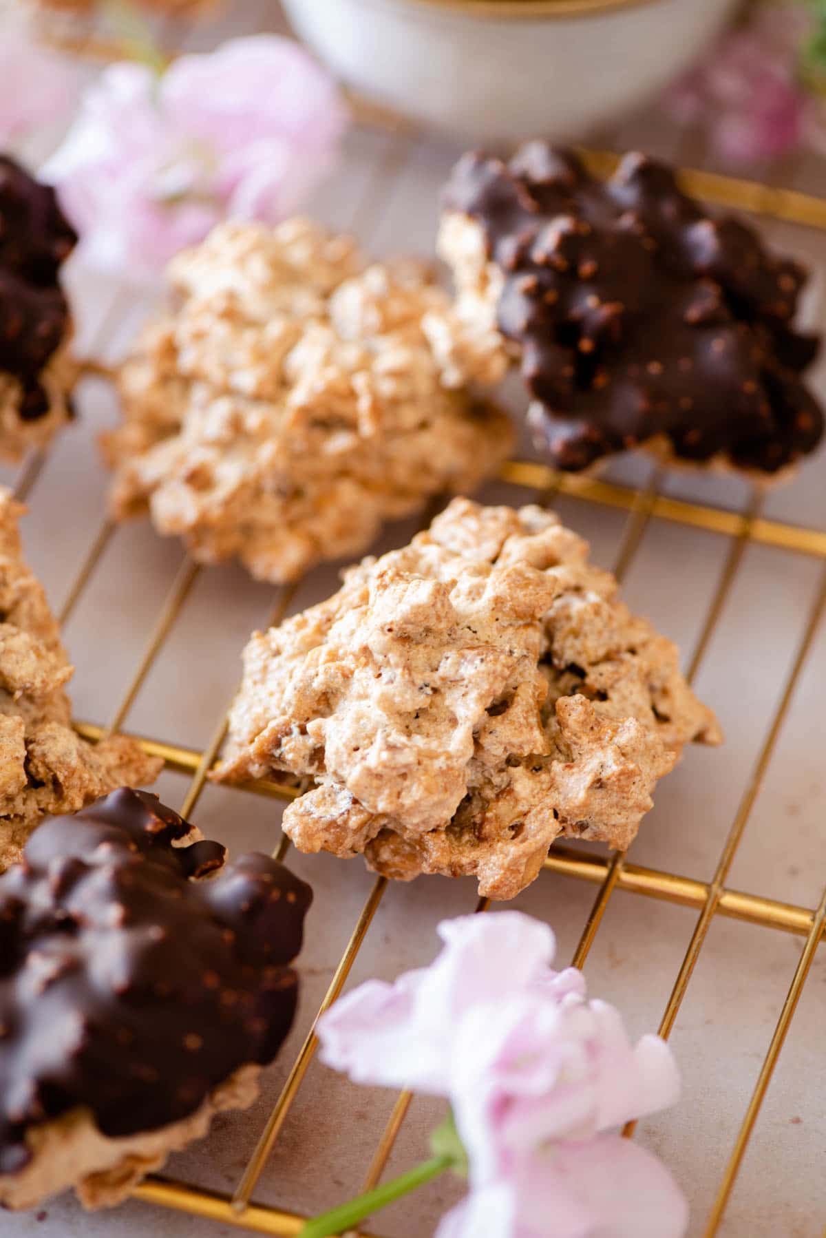 A close up of Brutti ma Buoni cookies on a gold cooling rack