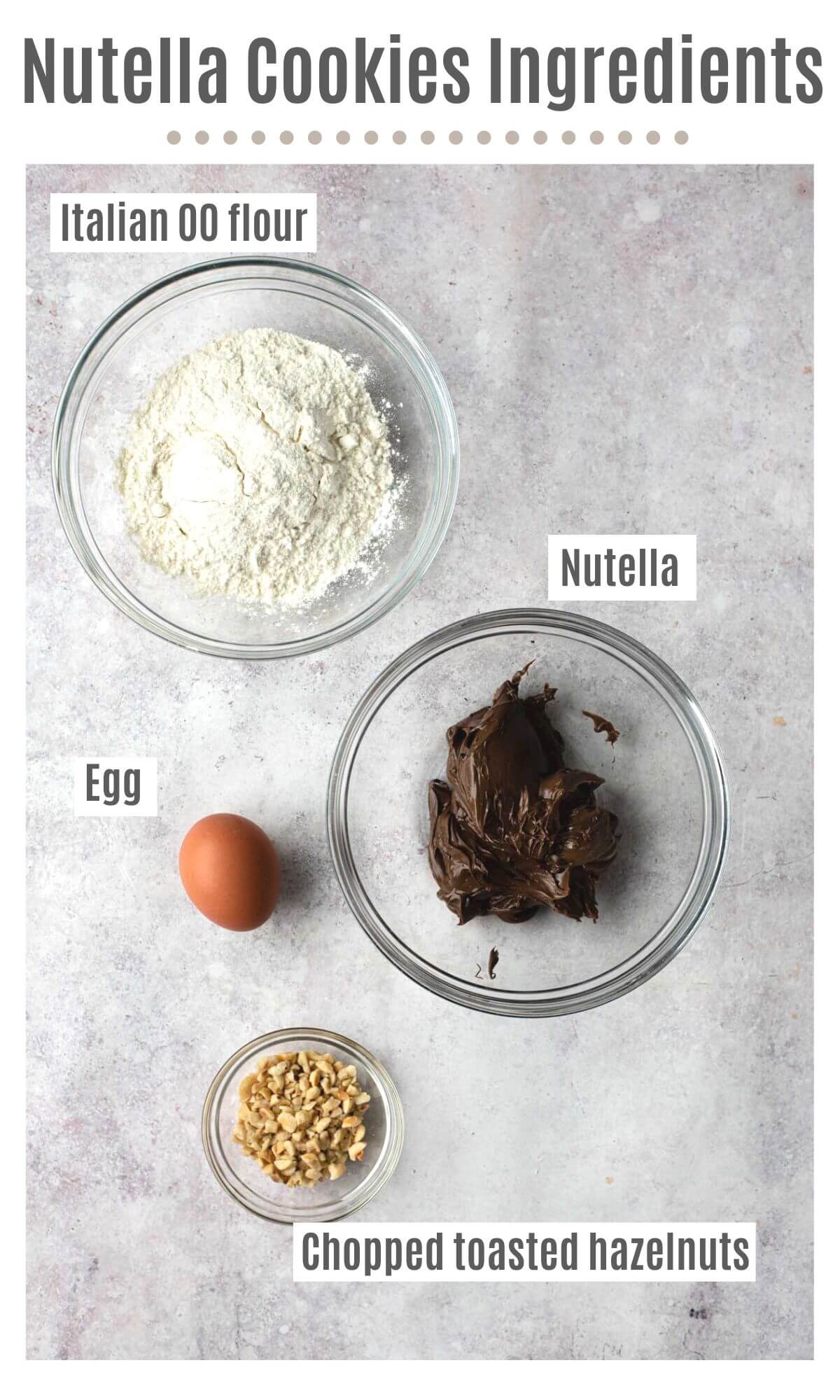 An overhead shot of all the ingredients you need to make Nutella cookies; flour, Nutella, egg and chopped toasted hazelnuts.