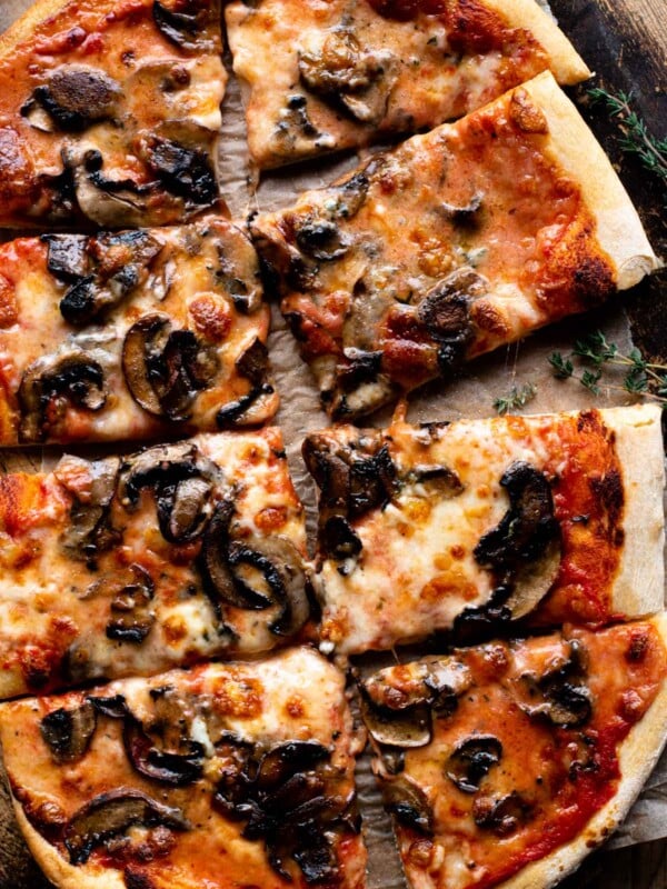 An overhead shot of a Taleggio and Mushroom Pizza cut into 8 slices.
