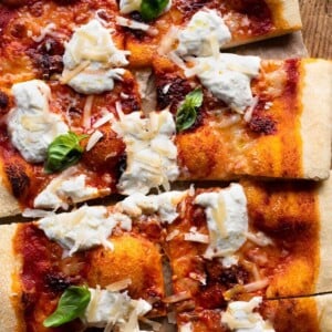 A close up of slices of pizza with Nduja and burrata.