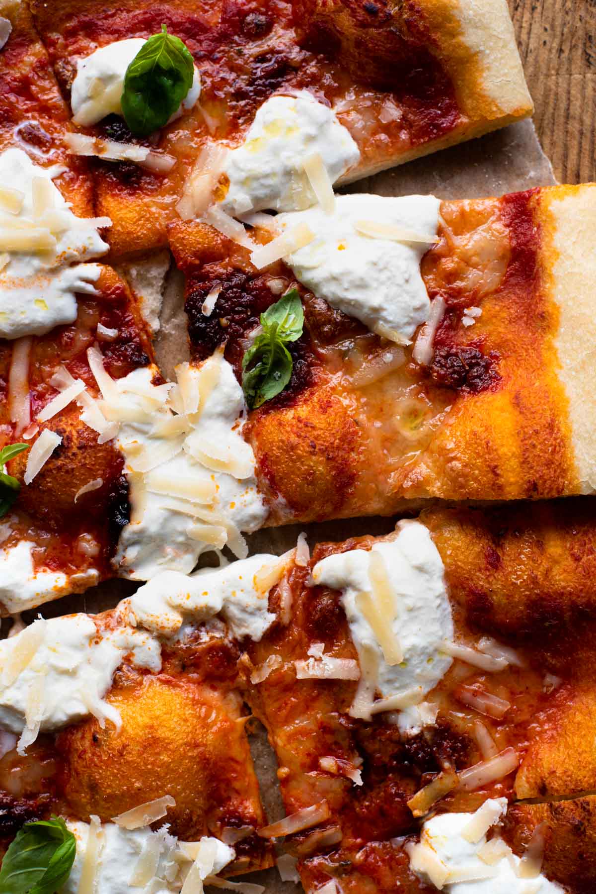 A close up of slices of pizza with Nduja and burrata cheese.