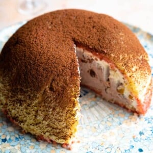 A close up cropped image of an Italian Zuccotto dessert with a slice cut out.