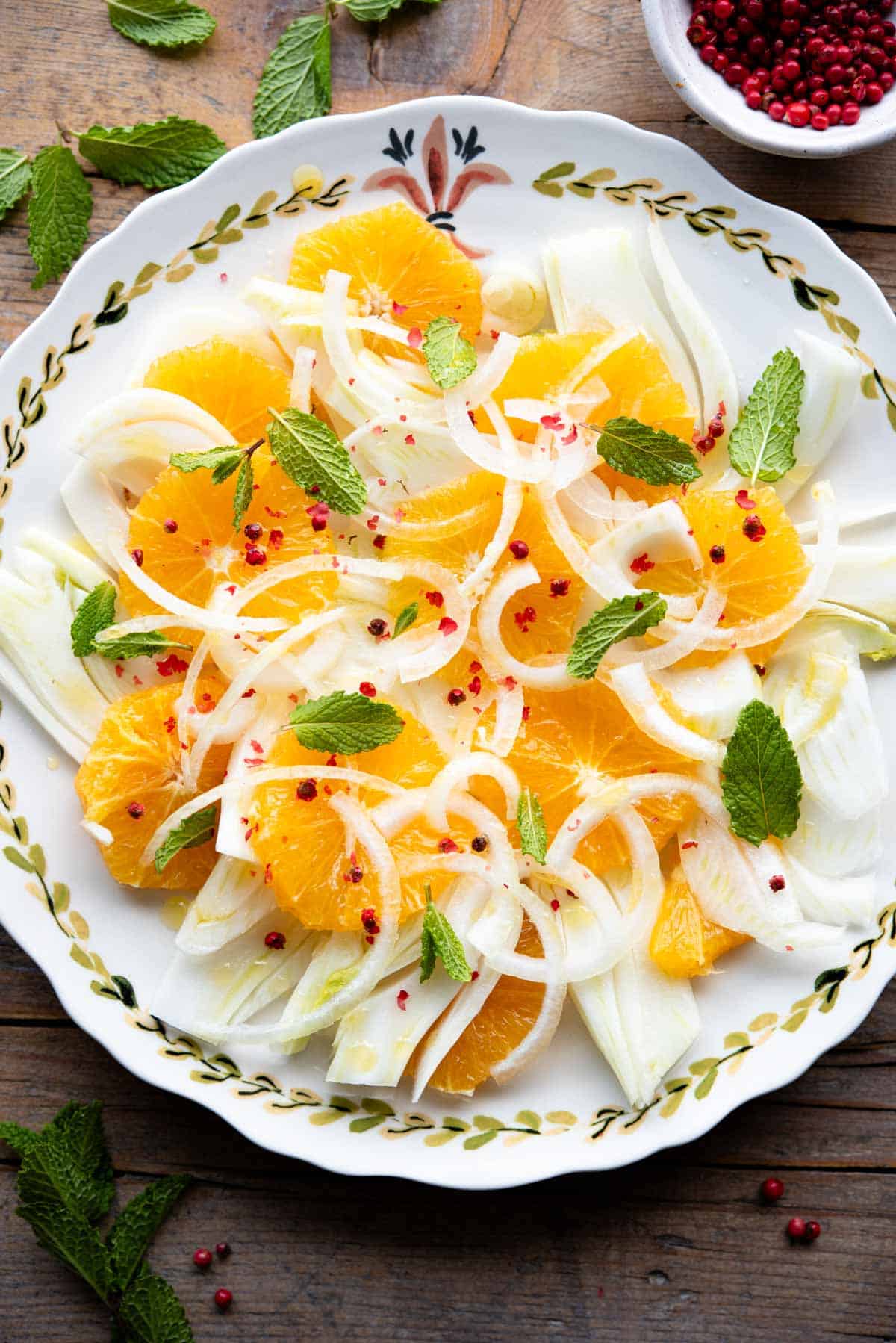 An overhead shot of a fennel and orange salad on a serving plate.