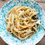 A cropped square image of roasted fennel pasta in a blue bowl.