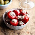 A close up of tuna stuffed cherry peppers in a small dish.