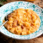 A cropped image of Pasta e Patate in a blue speckled bowl.