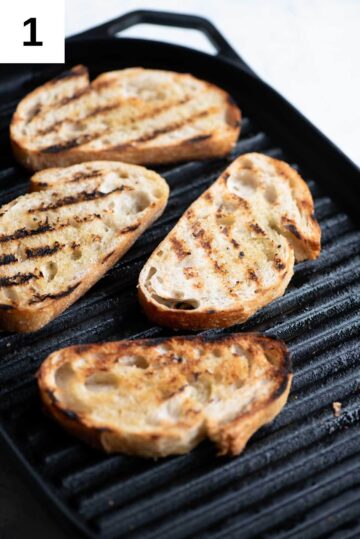 Slices of crusty bread getting char-grilled on a griddle pan.