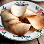 A close up of Tegole Valdostane (Italian cookies) on a plate.