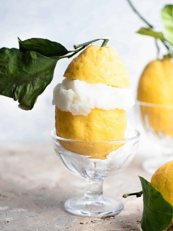 Italian lemon sorbet served in a large Amalfi lemon with leaves attached.